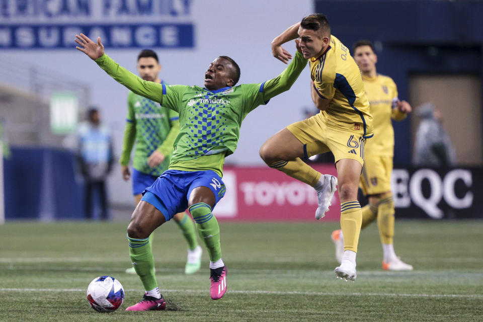 Seattle Sounders defender Nouhou Tolo (5) is fouled by Real Salt Lake midfielder Braian Ojeda (6) during the second half of an MLS soccer match Saturday, March 4, 2023, in Seattle. (AP Photo/Jason Redmond)