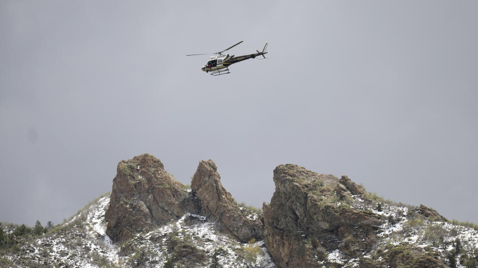 A Utah Department of Public Safety helicopter carries rescuers from Hidden Valley Park, Thursday, May 9, 2024 Thursday, May 9, 2024, in Sandy, Utah. One skier was rescued and two remained missing following an avalanche in the mountains outside of Salt Lake City. The slide happened after several days of spring snowstorms. (AP Photo/Rick Bowmer)