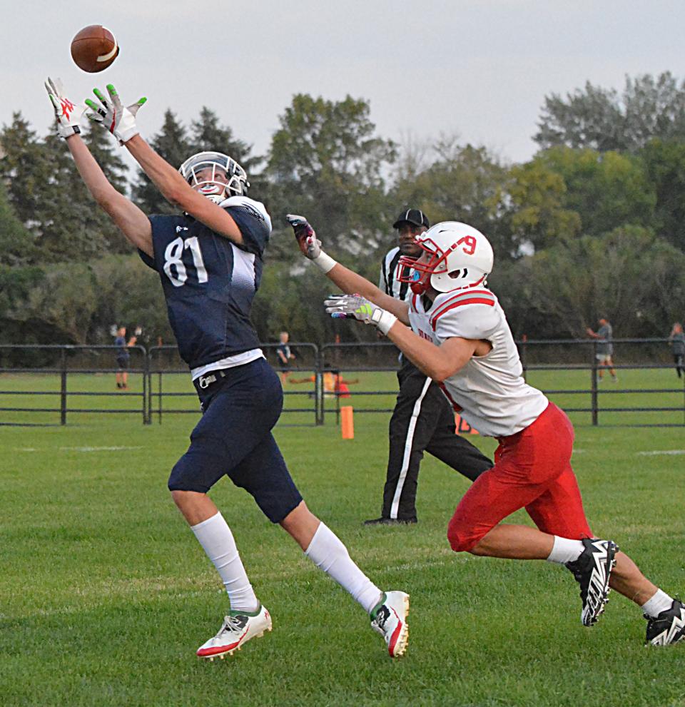 Great Plains Lutheran's Alex Heil reaches for a pass against Britton-Hecla's Bennett Suther during their season-opening high school football game on Friday, Aug. 18, 2023 at Watertown Stadium.