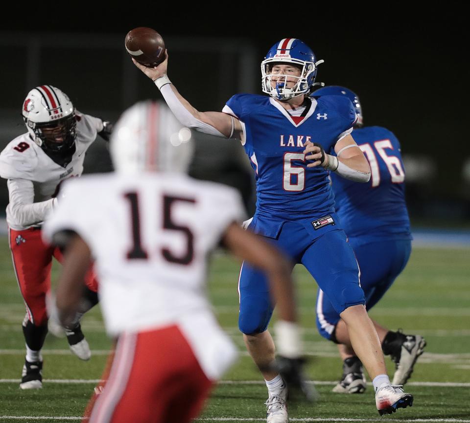 Lake's Will Butler throws as McKinley's Kylier Jenkins (9) pursues and John Chance (15) covers in the secondary during a high school football game at Lake on Friday, September 30, 2022.