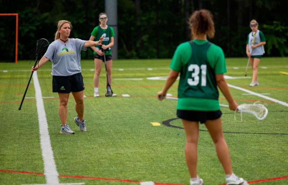 Coach Patricia Alexander leads her girls’ lacrosse team, that includes her daughter Taylor Alexander (31), during a practice at Cardinal Gibbons High School on Wednesday, May 8, 2024.