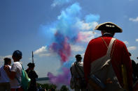 <p>David Embrey of Savage, MD watches fireworks as people gather to celebrate the Fourth of July at George Washington’s Mount Vernon on Wednesday July 04, 2018 in Mount Vernon, Va. Embrey was portraying a Colonial Army fifer. (Photo: Matt McClain/The Washington Post via Getty Images) </p>