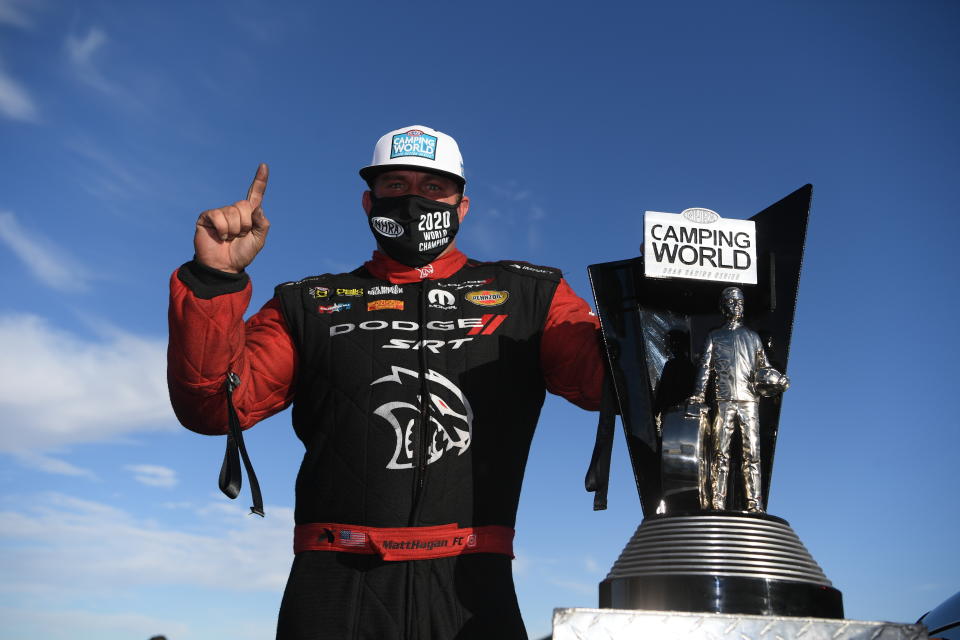 In this photo provided by the NHRA, Funny Car's Matt Hagan scored his third world title at Dodge NHRA Finals presented by Pennzoil and went on to win the event over teammate Ron Capps thanks to his 3.914-second pass at 326.40 mph, Sunday, Nov. 1, 2020, in Las Vegas. (Jerry Foss/NHRA via AP)