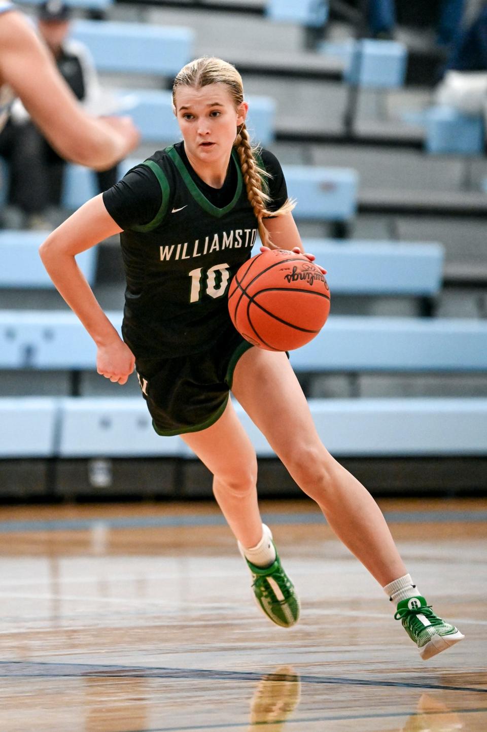 Williamston's Claire Casey moves the ball against Lansing Catholic during the third quarter on Tuesday, Dec. 12, 2023, at Lansing Catholic High School.