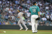 Seattle Mariners starting pitcher Yusei Kikuchi (18) waits as Oakland Athletics' Matt Olson, left, rounds the bases after hitting a solo home run during the fourth inning of a baseball game Friday, July 23, 2021, in Seattle. (AP Photo/Ted S. Warren)