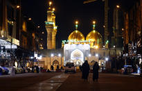 Shiite faithful pilgrims visit the shrine of Imam Moussa al-Kadhim in Baghdad, Iraq, despite a curfew imposed by the government to help fight the spread of the coronavirus, Saturday, Feb. 20, 2021. Mosques and schools are closed, large gatherings prohibited, and the wearing of masks and other protective gear will be enforced, according to a statement from the government. (AP Photo/Hadi Mizban)