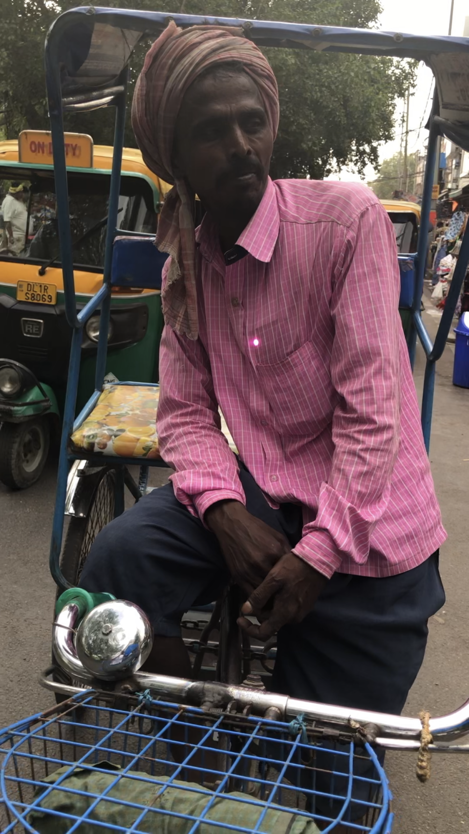 Rickshaw driver Shiv Kumar Mandal waits for his next fare in the shopping district of Delhi, India, amid a blistering heat wave, May 20, 2022. / Credit: CBS News