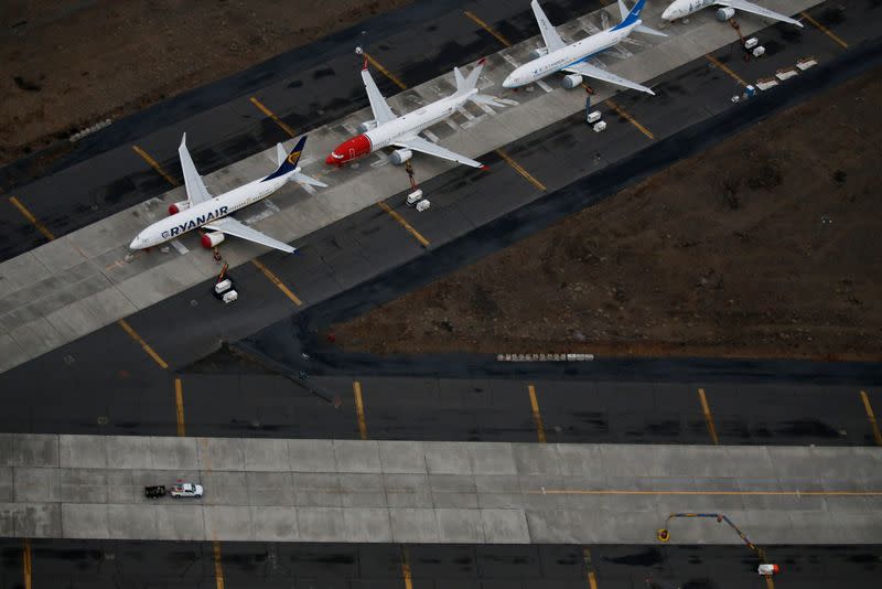 A truck drives by a line of grounded Boeing 737 MAX aircraft parked at Grant County International Airport in Moses Lake