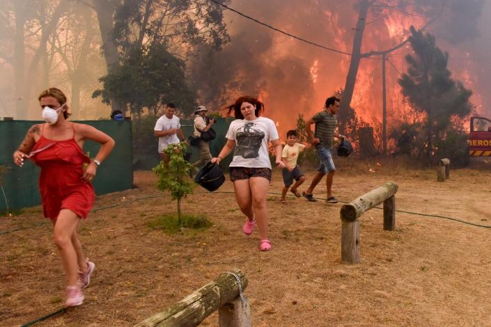 People flee from flames as fire breaks out in La Floresta, Uruguay (EPA)