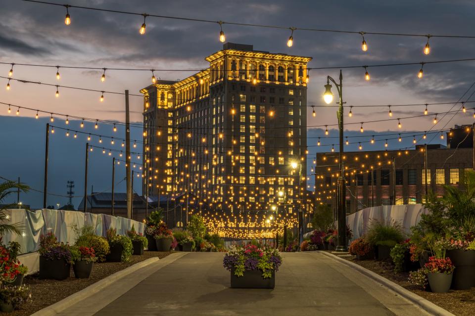 The newly reopened Michigan Central Station is lit up at dusk.