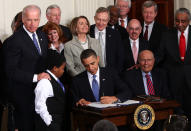 President Barack Obama signs the Affordable Health Care for America Act during a ceremony with fellow Democrats in the East Room of the White House March 23, 2010 in Washington, DC. The historic bill was passed by the House of Representatives Sunday after a 14-month-long political battle that left the legislation without a single Republican vote. (Photo by Win McNamee/Getty Images)