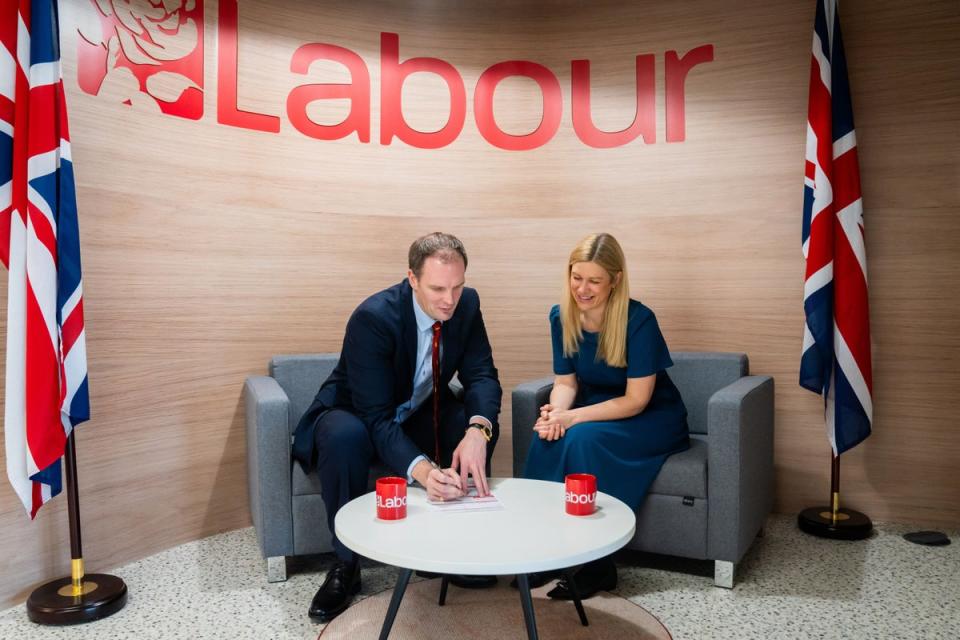 Dr Dan Poulter signing his Labour Party membership form with Ellie Reeves, Labour’s deputy national campaign co-ordinator (Labour Party/PA) (PA Media)