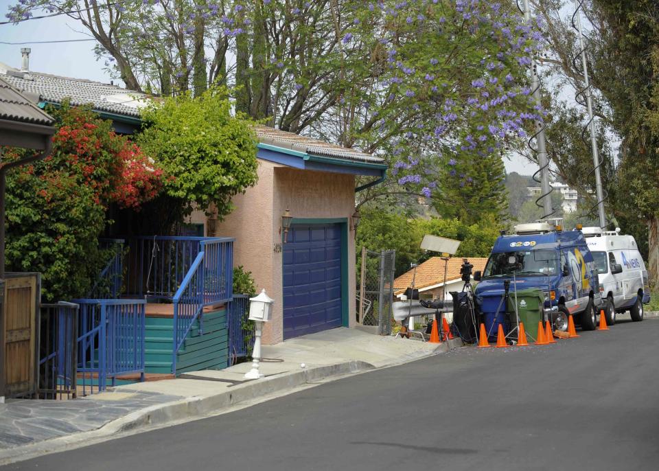 Media wait outside the home of director Peter Rodger in Woodland Hills, California