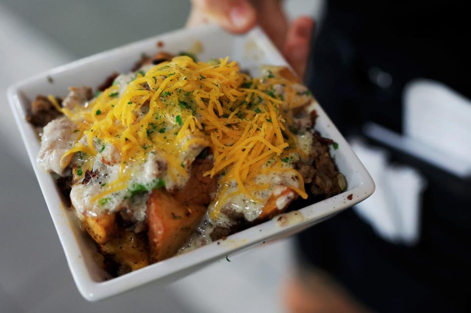 Tulua Bistro's "Slutty Potatoes" feature housemade cafe potatoes smothered in bacon, sausage, peppers, onions, sausage gravy and cheddar cheese.