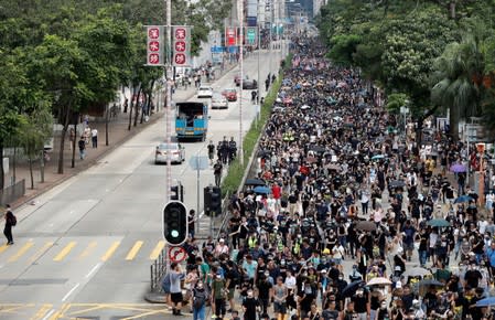 Anti-extradition bill protesters walk through Sham Shui Po neighbourhood in Hong Kong