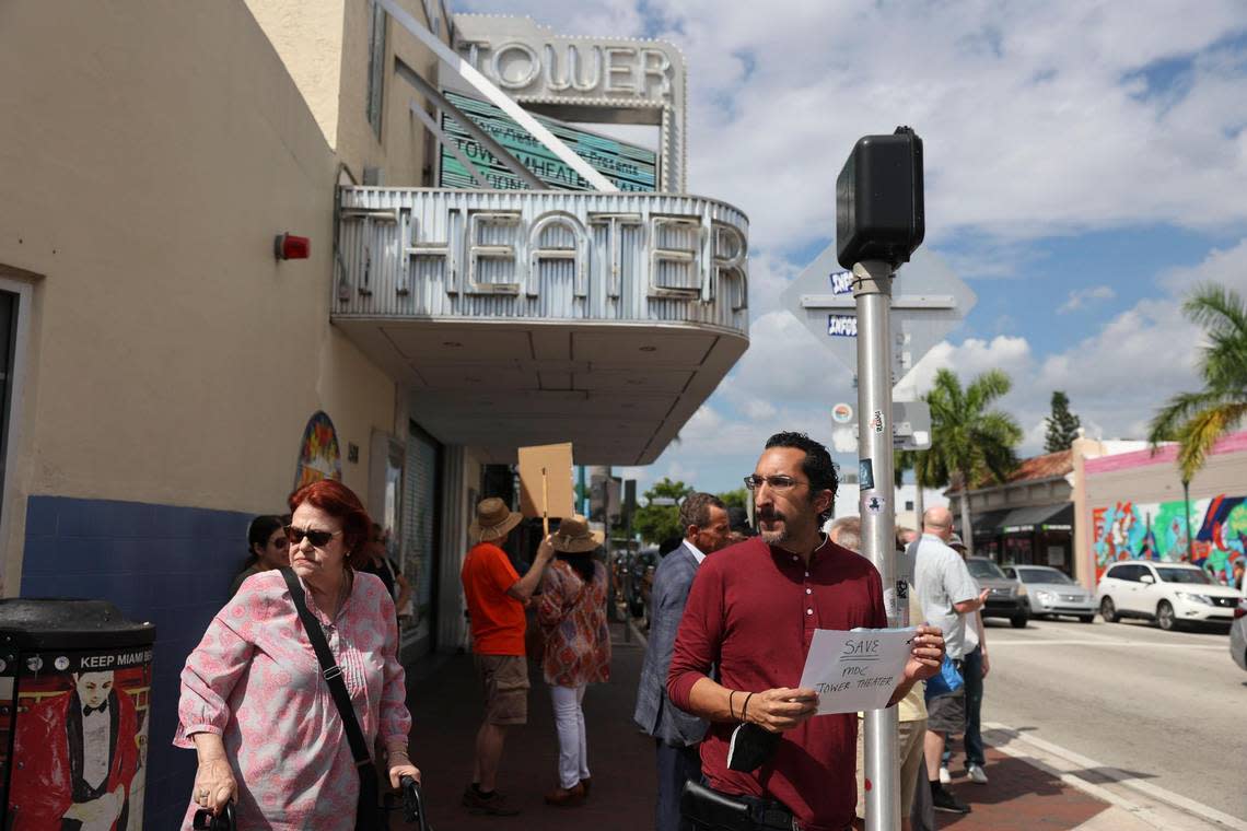 Gabriel Rhenals, right, holds a sign during the Miami Dade College Tower Theater protest on Tuesday, Oct. 4, 2022, in Little Havana. ‘Places like this offer pristine presentation, and it’s a shame to see art institutions folding,’ said Rhenals.