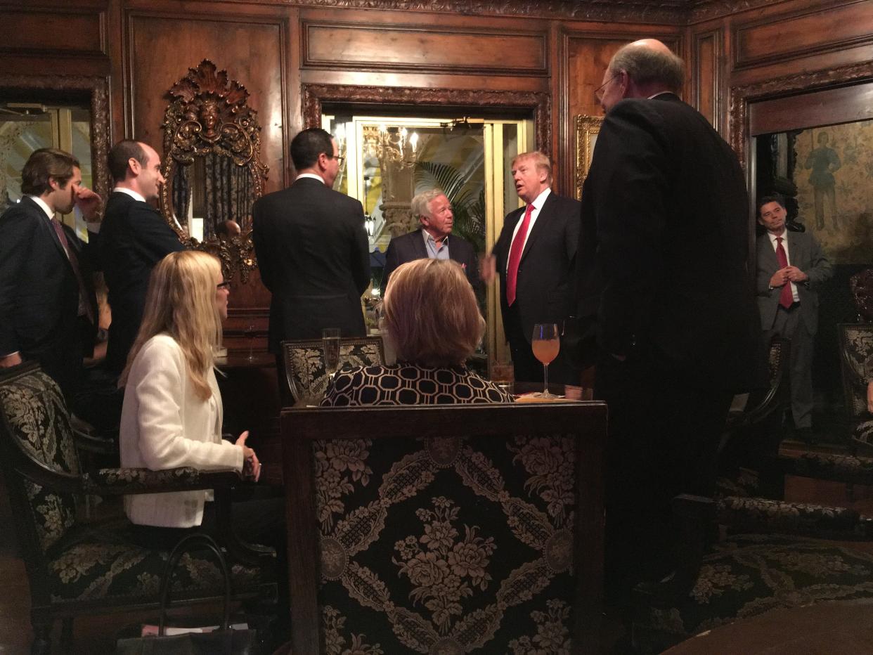 New England Patriots owner Robert Kraft, center, talks with President Donald Trump and others in the bar at Mar-a-Lago on April 7, 2017. [Shannon Donnelly/palmbeachdailynews.com]