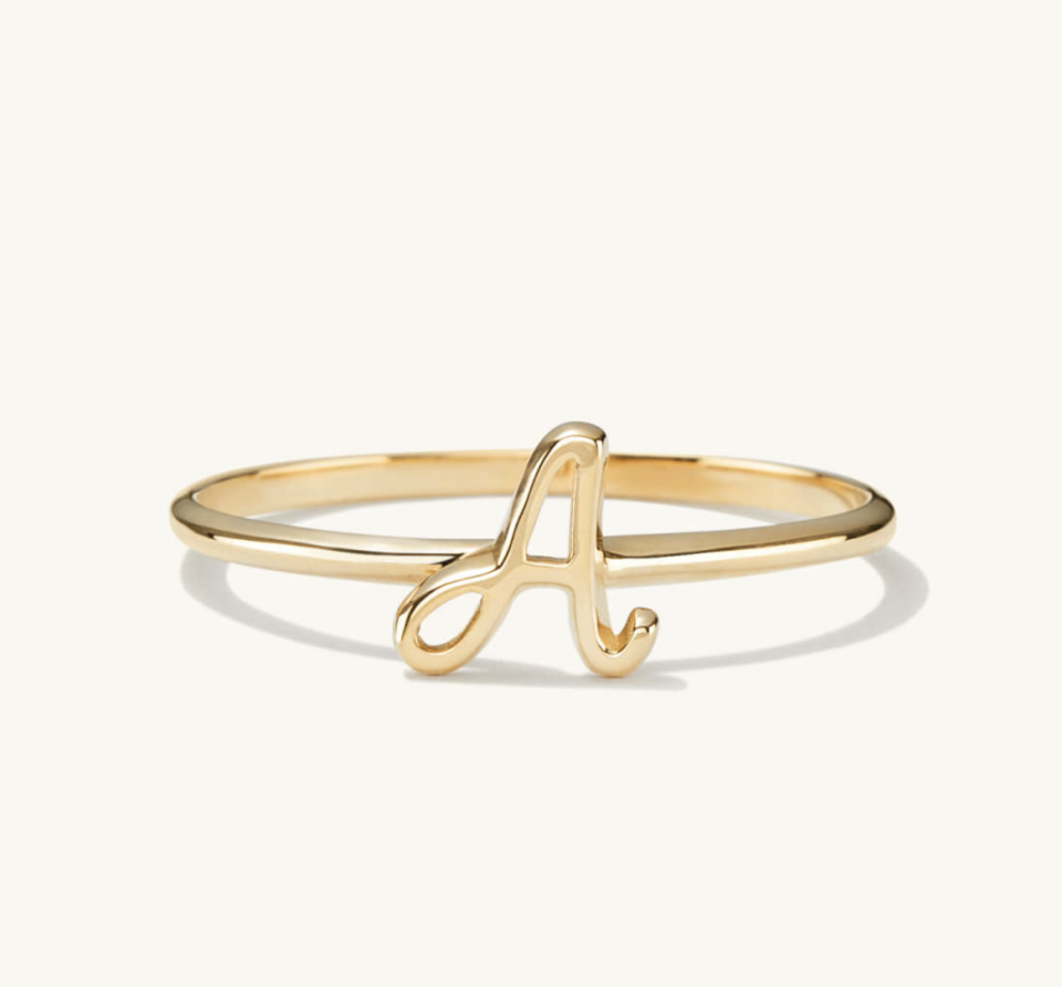 Cursive Letter Ring in gold with a (Photo via Mejuri)