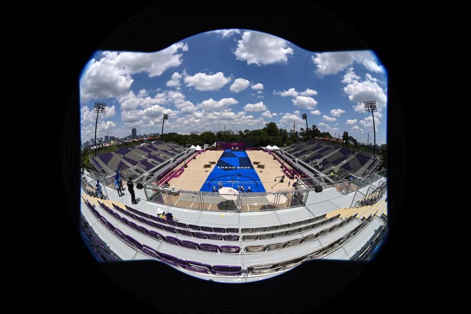 <p>This picture taken with a fisheye lens shows empty spectator seats as archers compete in the women's team eliminations during the Tokyo 2020 Olympic Games at Yumenoshima Park Archery Field in Tokyo on July 25, 2021. (Photo by ADEK BERRY / AFP)</p> 