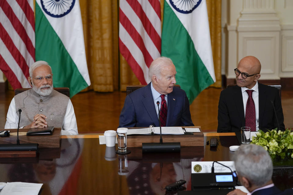 President Joe Biden speaks during a meeting with India's Prime Minister Narendra Modi and American and Indian business leaders in the East Room of the White House, Friday, June 23, 2023, in Washington. Satya Nadella, CEO of Microsoft, listens at right. (AP Photo/Evan Vucci)