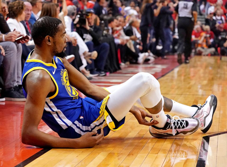 Jun 10, 2019: Golden State Warriors forward Kevin Durant (35) sits on the court after an apparent injury during the second quarter in game five against the Toronto Raptors of the 2019 NBA Finals at Scotiabank Arena.