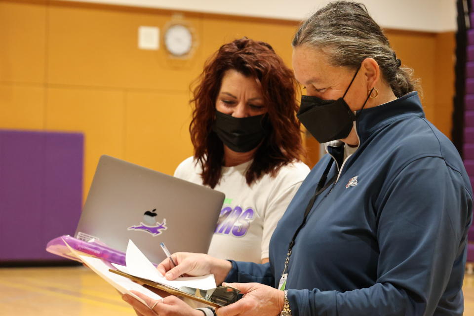 Michelle Reid, superintendent of the Northshore School District, talks to physical education teacher Kristi Smith while substituting in a gym class on Nov. 12 at North Creek High School in Bothell, Wash.<span class="copyright">Courtesy of Northshore School District</span>