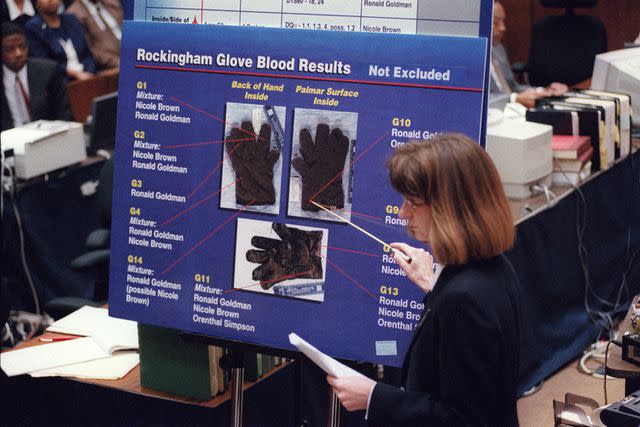 <p>VINCE BUCCI/AFP via Getty</p> California Department of Justice criminalist Renee Montgomery points to blood spots found on the leather glove at O. J. Simpson's Rockingham estate during re-direct examination in the O. J. Simpson double murder trial in Los Angeles