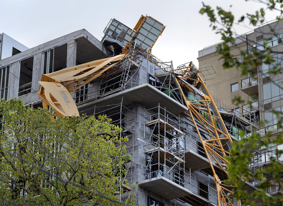 A toppled building crane is draped over a new construction project after Hurricane Dorian swept through the area in Halifax, Nova Scotia, on Sunday, Sept. 8, 2019. Hurricane Dorian brought wind, rain and heavy seas that knocked out power across the region, left damage to buildings and trees as well as disruption to transportation. (Andrew Vaughan/The Canadian Press via AP)