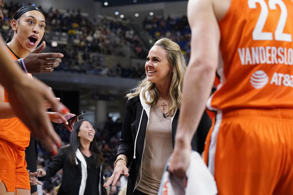 Team Wilson coach Becky Hammon looks at Dearica Hamby, left, during the first half of the WNBA All-Star basketball game against Team Stewart in Chicago, July 10, 2022. Recent allegations by Hamby that Las Vegas Aces coach Hammon, one of the league's marquee figures and a six-time WNBA All-Star, harassed her for being pregnant have shined a renewed spotlight on one of the biggest challenges that female professional athletes face. The athletes say that pregnant athletes continue to encounter attitudes ranging from ambivalent to outright hostile from leagues, coaches — and even fellow players. (AP Photo/Nam Y. Huh)