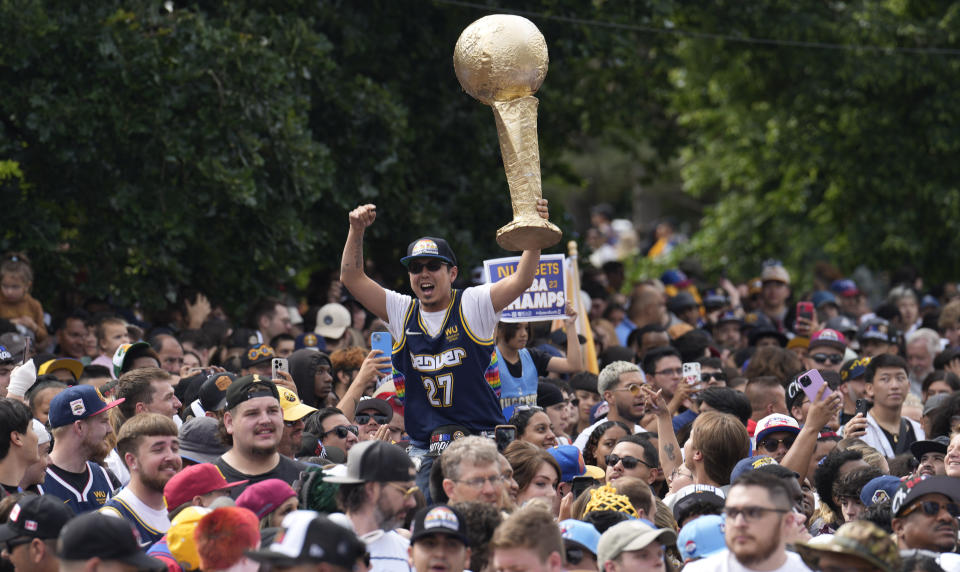 Fans celebrate during a rally and parade to mark the Denver Nuggets first NBA basketball championship on Thursday, June 15, 2023, in Denver. (AP Photo/David Zalubowski)