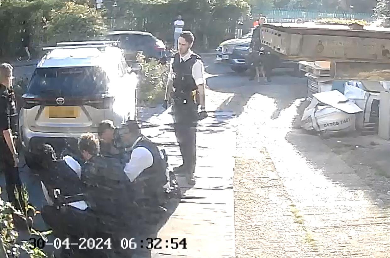 NUMBERPLATE PIXELATED BY PA PICTURE DESK Handout footage from a doorbell camera of police officers tasering and detaining a sword-wielding man in Hainault, north east London, after a 14-year-old boy died after being stabbed following an attack on members of the public and two police officers. Picture date: Tuesday April 30, 2024.