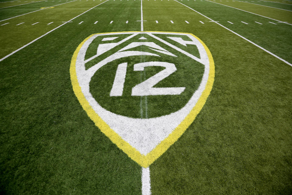 ADVANCE FOR SATURDAY, OCT. 1 - In this Oct. 10, 2015, file photo,  a PAC-12 logo is seen painted on the field before an NCAA college football game between Washington State and Oregon in Eugene, Ore. Larry Scott helped transform and modernize the Pac-12 when he took over as commissioner, helped the conference land a $3 billion TV deal and create its own network. Eight years later, the conference is reaping financial rewards and he believes it is well-positioned to adapt to the changing landscape of both college sports and media rights. (AP Photo/Ryan Kang, File)