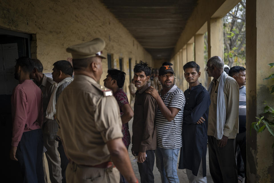 People stand in queue to vote during the third round of voting in the six-week-long general election in Agra, Uttar Pradesh, India, Tuesday, May 7, 2024. (AP Photo/Altaf Qadri)