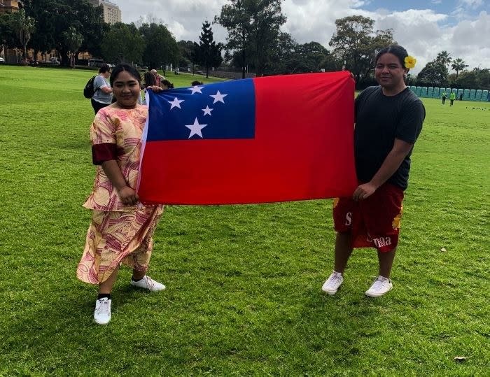 Two people holding a flag