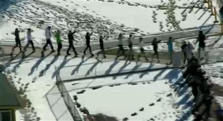 Students from Arapahoe High School evacuate their building in Centennial, Colorado December 13, 2013 in this still image from video Courtesy KUSA, Channel 9 during a shooting incident in which at least two students were injured. Police reported the gunman took his own life. REUTERS/Courtesy KUSA, Channel 9