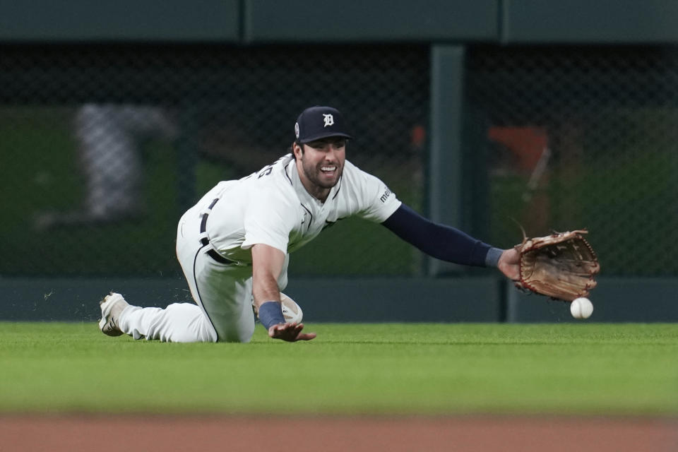 Detroit Tigers right fielder Matt Vierling dives but can't catch a Cincinnati Reds' Harrison Bader fly ball in the fifth inning of a baseball game, Tuesday, Sept. 12, 2023, in Detroit. (AP Photo/Paul Sancya)