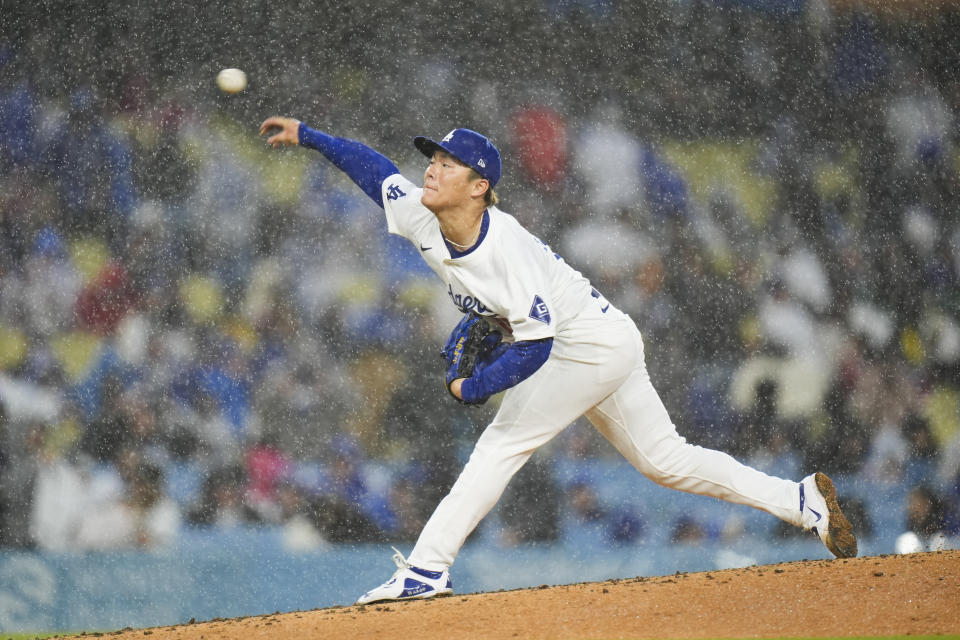 Los Angeles Dodgers starting pitcher Yoshinobu Yamamoto throws against the St. Louis Cardinals as rain falls during the fourth inning of a baseball game Saturday, March 30, 2024, in Los Angeles. (AP Photo/Jae C. Hong)
