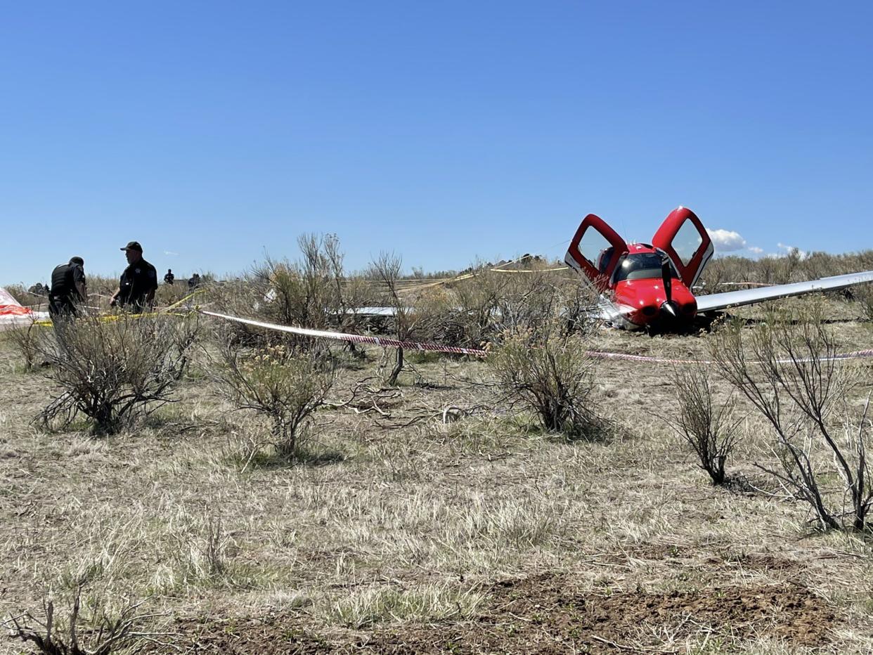 Police attend to the scene after a mid-air collision that occurred over Cherry Creek State Park.