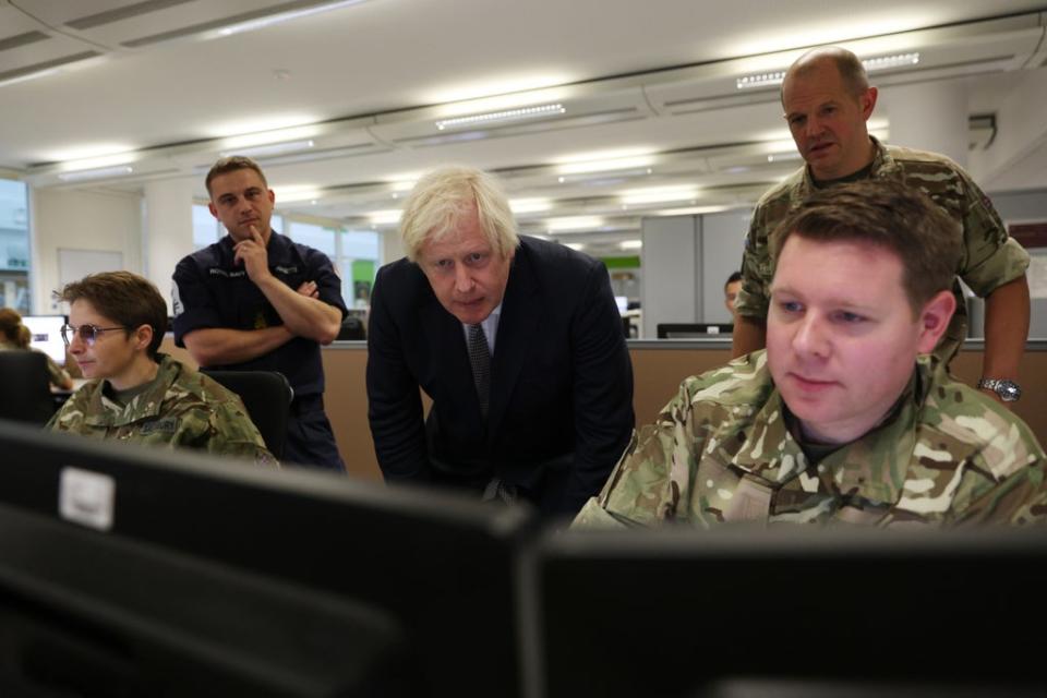 Prime Minister Boris Johnson observes the operations room for the Afghan Relocation and Assistance Policy during a visit to Northwood Headquarters, the British Armed Forces Permanent Joint Headquarters, in Eastbury, north-west London, where he met with personnel working on the UK operation in Afghanistan ((Adrian Dennis/PA))