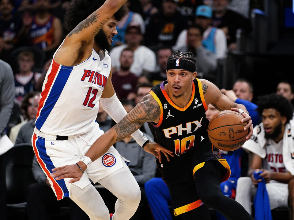 Phoenix Suns' Damion Lee (10) drives around Detroit Pistons' Isaiah Livers (12) during the second half of an NBA basketball game in Phoenix, Friday, Nov. 25, 2022. (AP Photo/Darryl Webb)