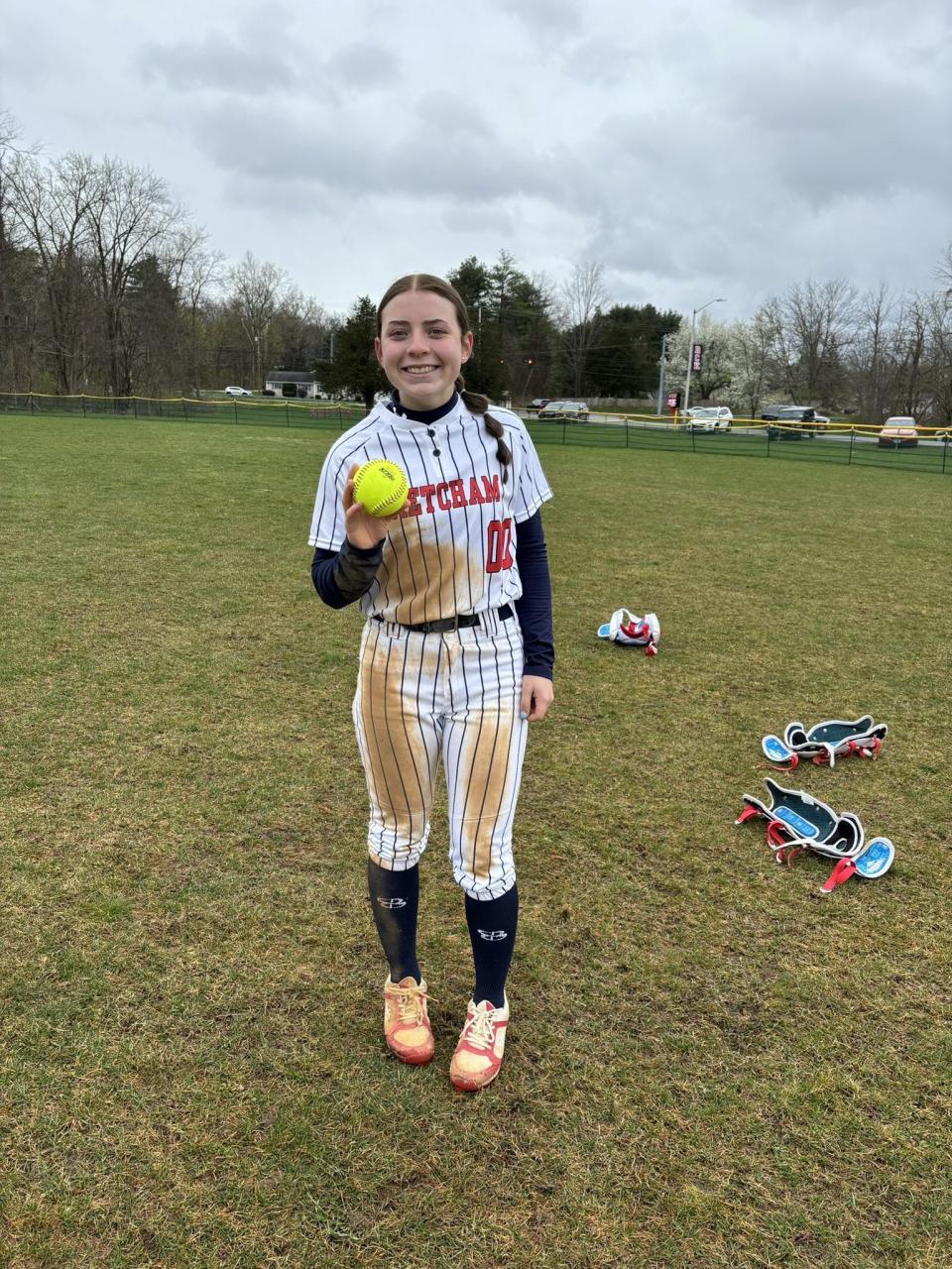 Ketcham's Kaelyn Brenner poses with the souvenir ball after the sophomore hit her first varsity home run in a win over Mamaroneck on April 13, 2024.