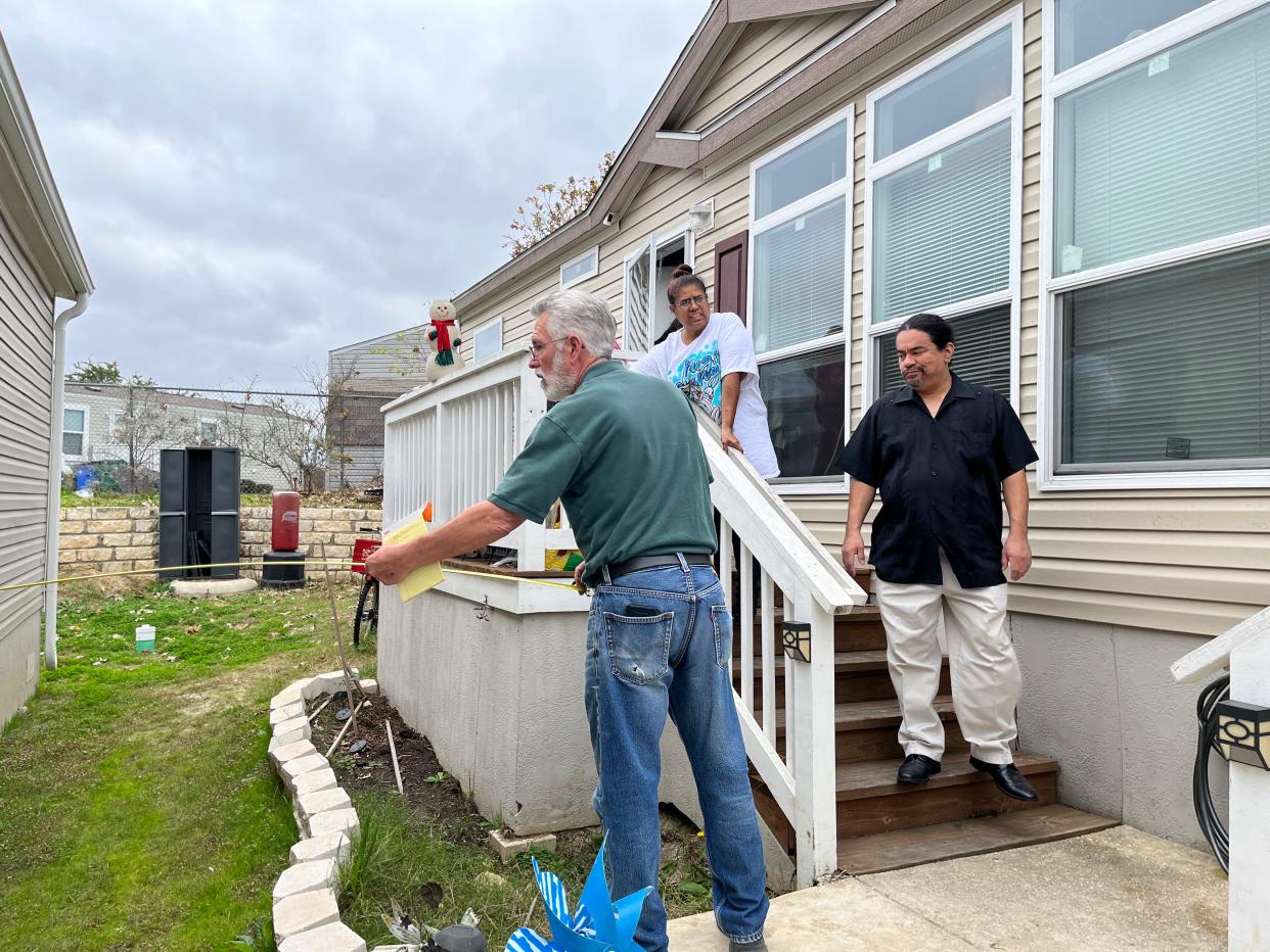 Danny Scott of CG&S Design-Build takes measurements Friday while trying to figure out how to build an accessible ramp at the home of Betty Patina-Trujillo and Ruben Trujillo. Patina-Trujillo has multiple sclerosis and son Margarito has had back surgery for scoliosis.