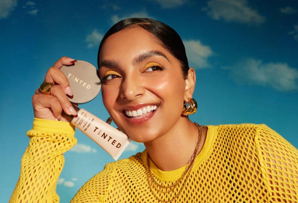 woman holding Live Tinted products