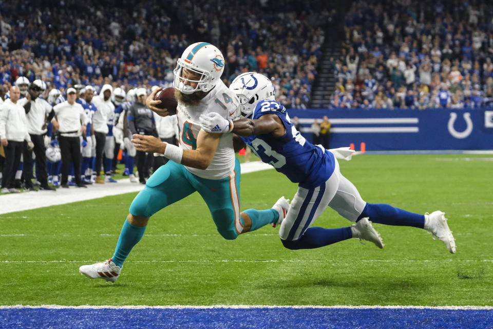 Miami Dolphins quarterback Ryan Fitzpatrick (14) breaks the tackle of Indianapolis Colts cornerback Kenny Moore (23) to score a touchdown during the first half of an NFL football game in Indianapolis, Sunday, Nov. 10, 2019. (AP Photo/AJ Mast)