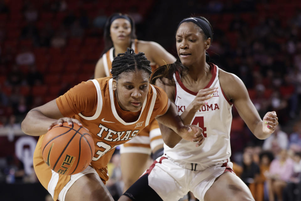 Texas forward Madison Booker, left, drives the ball against Oklahoma guard Kennady Tucker during the first half of an NCAA college basketball game Wednesday, Feb. 28, 2024, in Norman, Okla. (AP Photo/Garett Fisbeck)