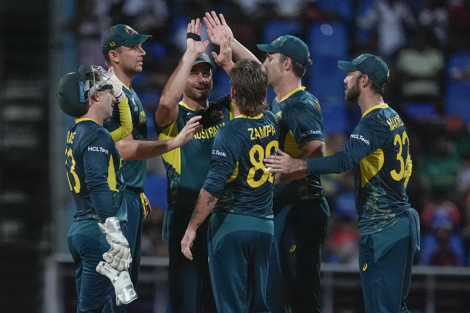 Australia's Adam Zampa, centre, is congratulated by teammates after taking the wicket of Bangladesh's Najmul Hossain Shanto during the ICC Men's T20 World Cup cricket match between Australia and Bangladesh in North Sound, Antigua and Barbuda, Thursday, June 20, 2024. (AP Photo/Lynne Sladky)