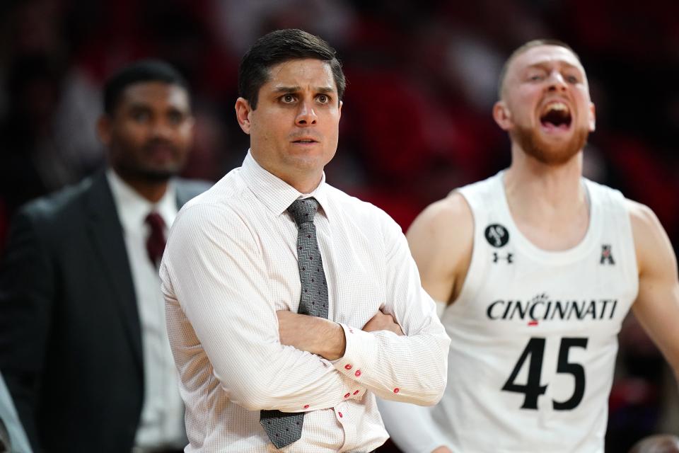 Cincinnati Bearcats head coach Wes Miller observes the team in the first half of an NCAA men's college basketball game against the Miami (Oh) Redhawks, Wednesday, Dec. 1, 2021, at Millett Hall in Oxford, Ohio. The Cincinnati Bearcats won, 59-58.