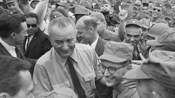 PHOTO: Cheering U.S. soldiers surround President Johnson as he arrives on an un-announced visit, Oct. 26, 1966, in Cam Ranh, Vietnam. (Bettmann Archive via Getty Images)