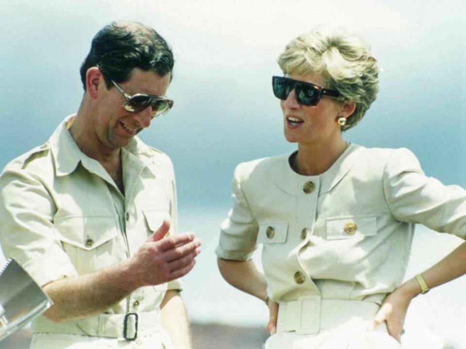 In this April 23, 1991 file photo, Britain's Prince Charles and Princess Diana, laugh together during their visit to an iron ore mine near Carajas, Brazil. Producers of a new documentary, to be aired Sunday, Aug. 6, 2017, about Princess Diana say it offers insight. Critics say it's nothing but exploitation.