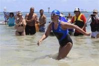 U.S. long-distance swimmer Diana Nyad , 64, walks to dry sand, completing her swim from Cuba as she arrives in Key West, Florida, September 2, 2013. REUTERS/Andrew Innerarity